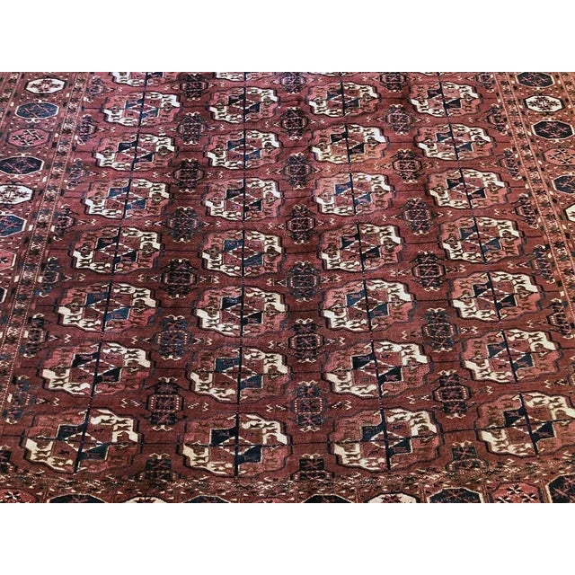 This carpet was likely woven by a member of the Yomut tribe of Central Asia. The staggered motifs seen in the carpet’s...