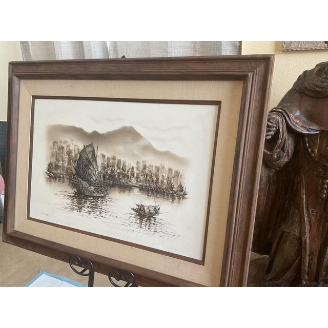 Beautiful vintage framed Asian harbor scene artwork featuring traditional fishing boats resting on calm waters with a...