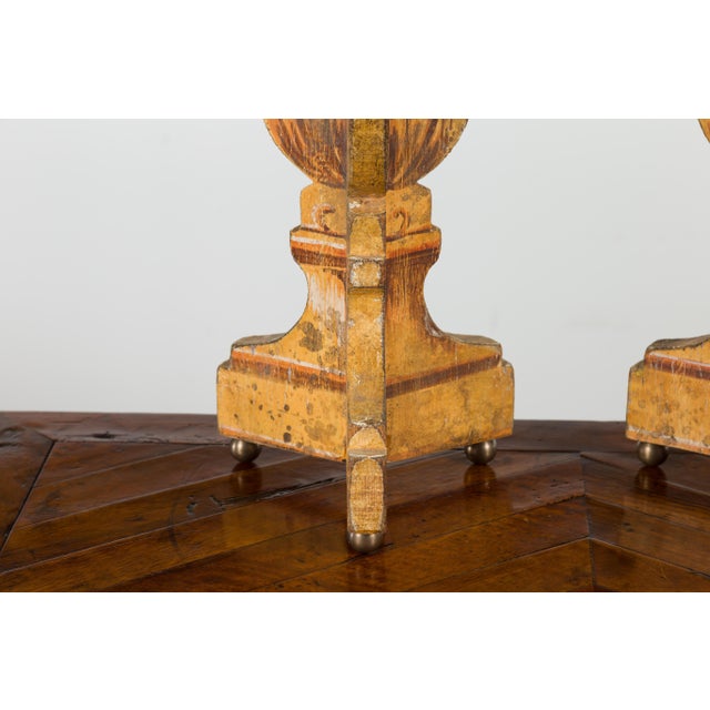 A pair of Italian vintage painted and carved table lamps from the mid-20th century, with stylized foliage decor and petite...