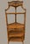 A beautifully detailed vintage rattan and bamboo corner étagère, featuring an elegant pagoda-inspired silhouette and...