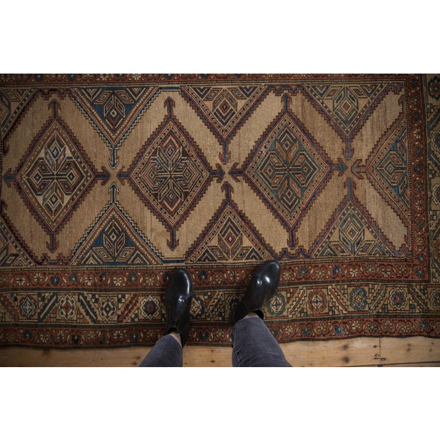 :: Diamond shaped repeating medallions in full and halved mapping with arrowed finials atop an abrashed ground and...