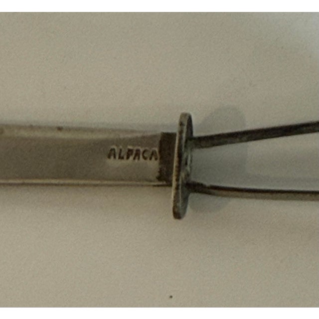 Small vintage alpaca silver letter opener or paper knife with an elegant curved blade and simple openwork handle topped by...