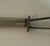 Small vintage alpaca silver letter opener or paper knife with an elegant curved blade and simple openwork handle topped by...