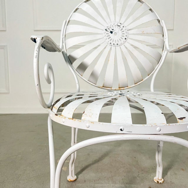 A set of 4 "Sunburst" wrought iron armchairs with comfortable spring seats and backs. Circa 1940’s. Designed by Francois...