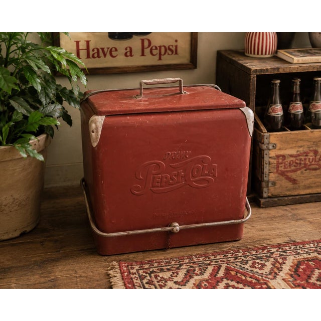 Bring authentic mid-century Americana into your home with this original embossed Drink Pepsi-Cola picnic cooler...