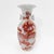 A bold and lively porcelain vase featuring vibrant red foo dogs among swirling clouds, symbolizing protection and power....