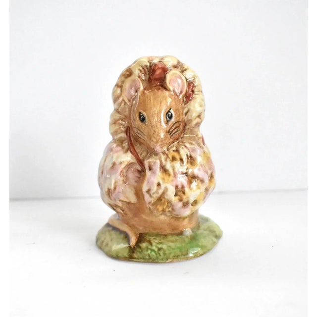 A vintage, 1981 Beatrix Potter figurine of Thomasina Tittlemouse, a little mouse in a fur coat with a hood and a fur stole.