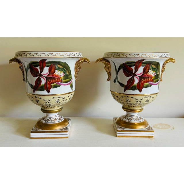 Vintage Chelsea House pair of neoclassical urn style planters. Features red iris on one side and pink roses on the other...