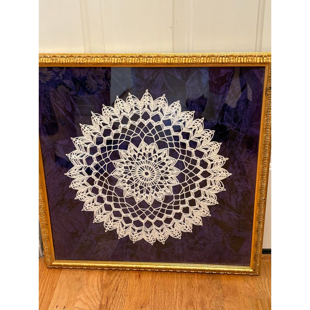 This vintage textile wall art featuring an intricate, hand-crocheted pineapple pattern lace doily which is carefully...