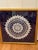 This vintage textile wall art featuring an intricate, hand-crocheted pineapple pattern lace doily which is carefully...