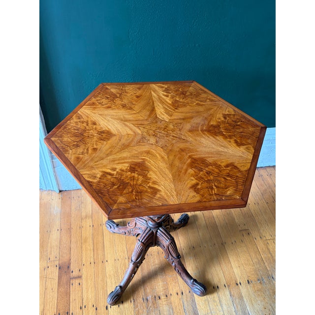 Regal Burled Ash Hexagon Tilt-Top Table. This masterfully veneered top sits atop a skillfully carved base. The mechanism...