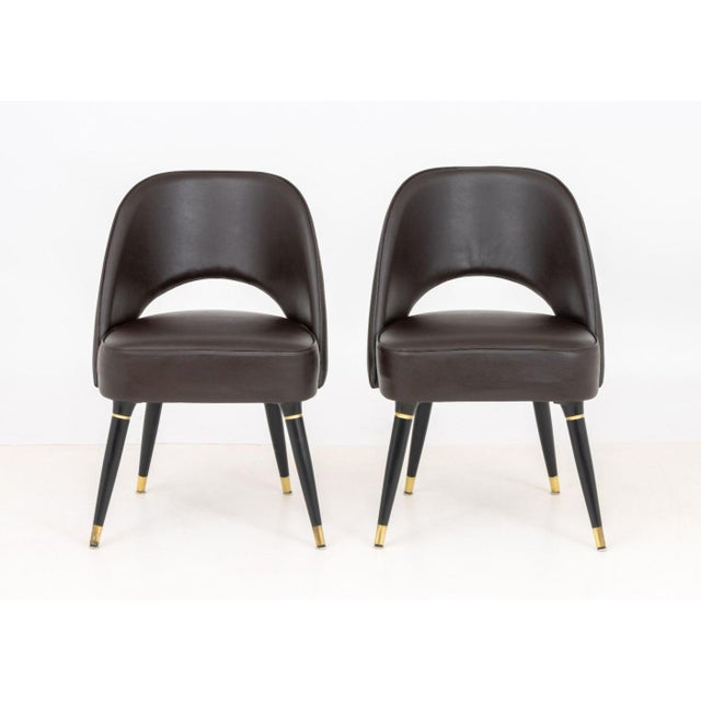 Pair of Mid-Century Modern Style Brown Leather Upholstered Side Chairs, atop ebonized tapered legs with brass accents. 33"...