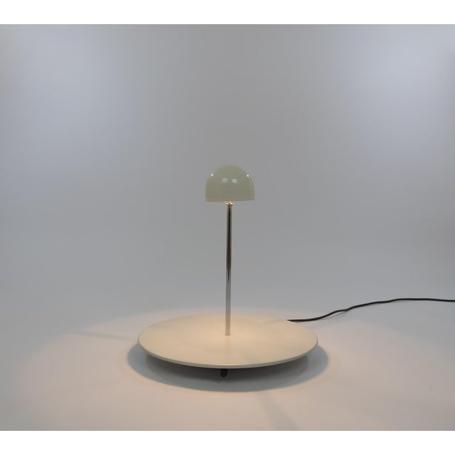 Nemea table lamp, designed by Vico Magistretti in 1979 and produced by Artemide. The model consists of a round base, with...