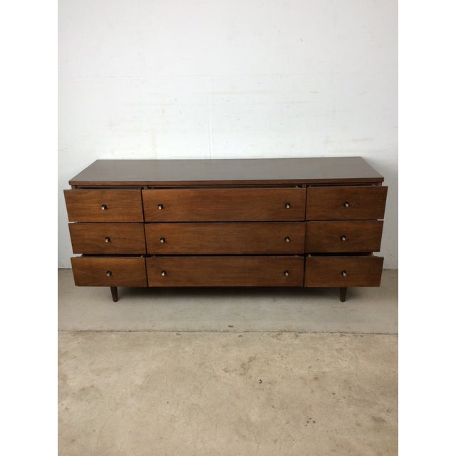 This mid century modern lowboy dresser by Stanley Furniture features hardwood construction, original walnut finish,...