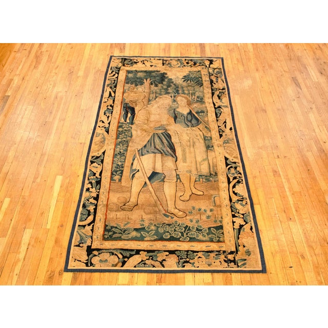 A European rustic tapestry from the 17th century, envisioning two peasant women working in the field in the foreground...