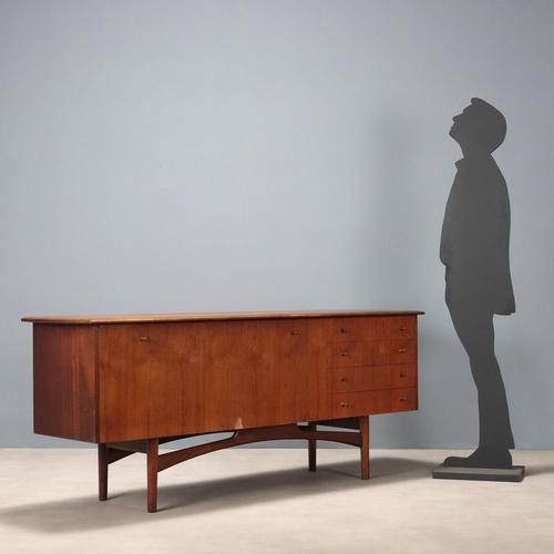 Vintage teak veneered sideboard with open drawers and large drop-down door for a spacious bar area. This piece is...