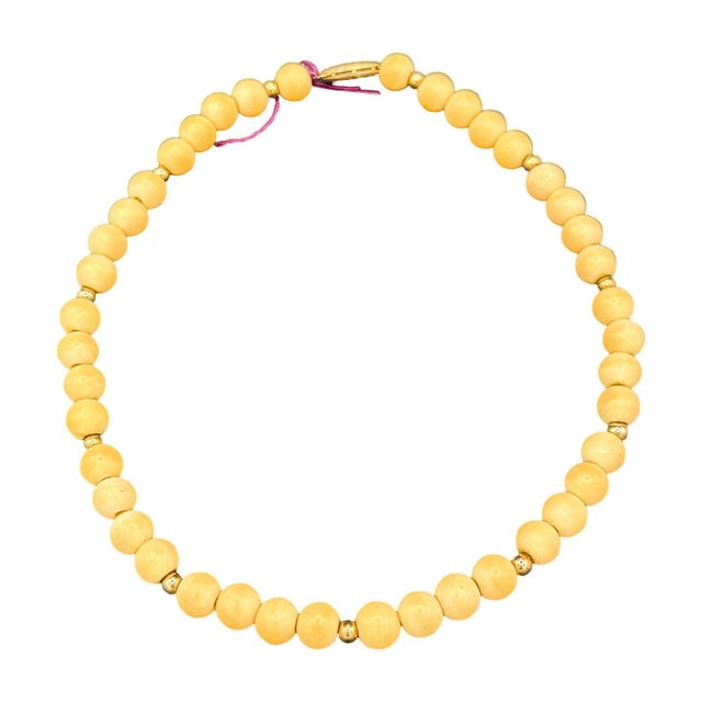 Mid-century coastal sponge coral necklace with gold plated beads and fishhook clasp. The necklace beads come with a cream...