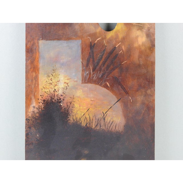 Early 20th century oil painting on wood artist palette featuring cat tails and moonlit lake. Unsigned and unframed. Edge...