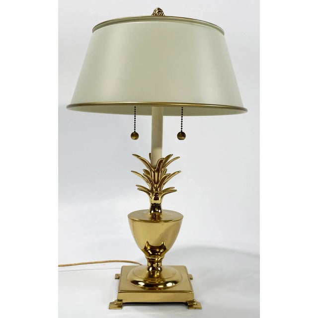 Vintage brass pineapple lamp with ivory metal tole shade. Lamp has double sockets with separate brass pulls for each bulb....
