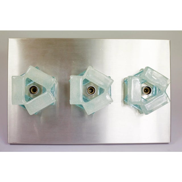 This wall lamp was designed by Albano Poli and manufactured by Poliarte. This lamp consists of a stainless steel plate on...