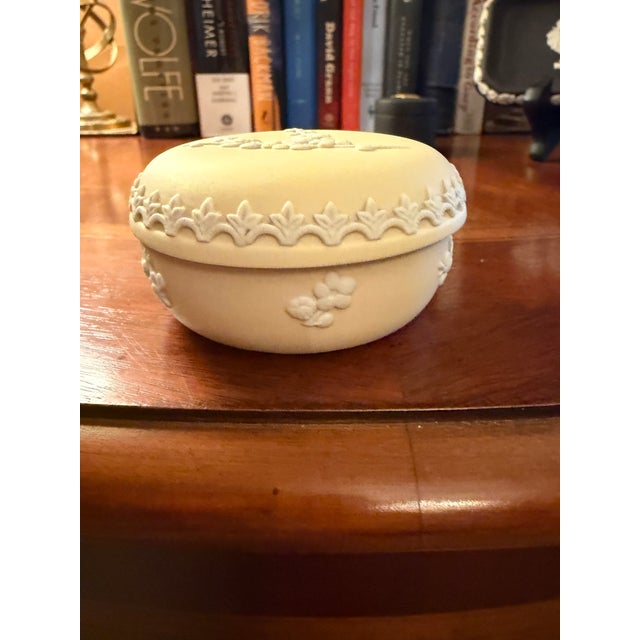 The Vintage Wedgwood Prunus Yellow Primrose Jasperware 2.75 Trinket Box and Lid is a charming collectible item made in the...