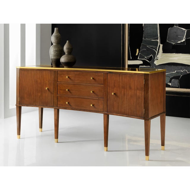 Crafted from rich walnut veneer, this sideboard boasts a sleek profile with clean lines, exuding timeless sophistication....