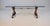 A 1960s gold gilt iron and glass Spanish/Hollywood Regency coffee table featuring scrolling, hand-gilded wrought iron base...