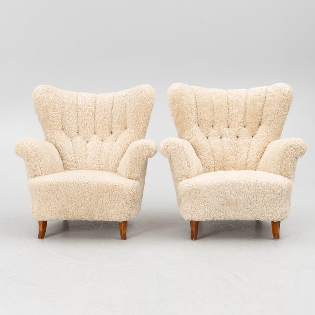 A pair of Swedish lounge chairs from the 1940s, fully upholstered and resting on birch legs. These have a very soft,...