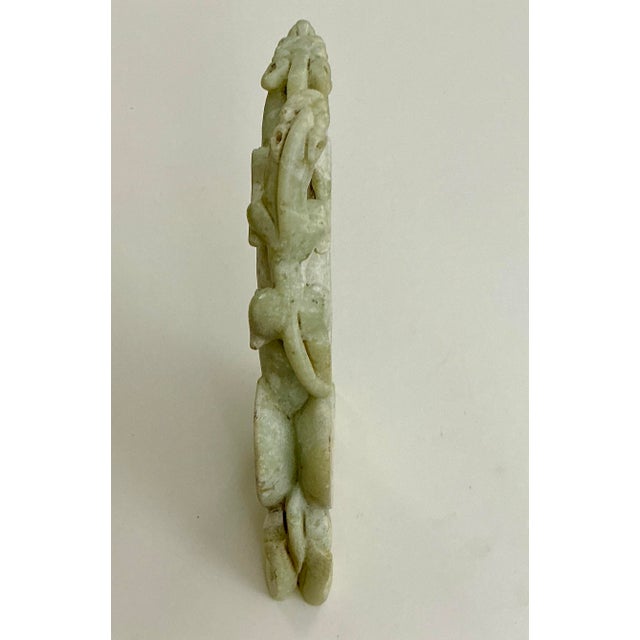 A finely carved archaic-style jade dragon bearing a pixiu on its back, likely late Qing / Republic period. Expertly worked...