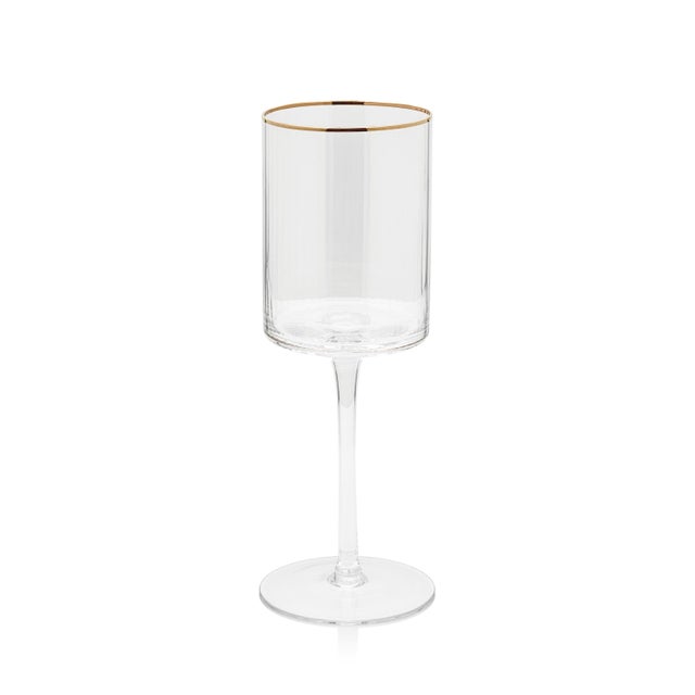 Update your glassware collection with this set of Ottica Wine Glasses. Decorated with gold tone rims, these clear glasses...