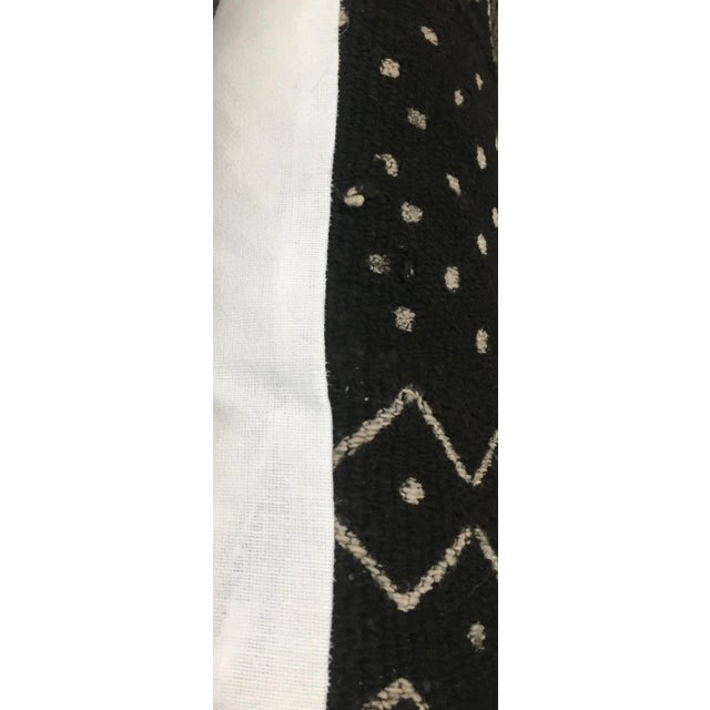 The wonderful playfulness and creativity of the craftspeople of Mali comes to life in this Black and off-white Mudcloth....