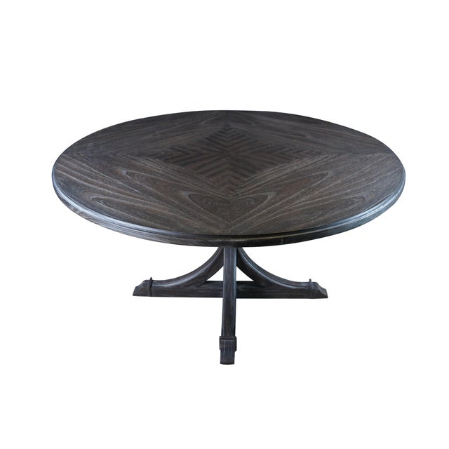 The Adams Dining Table’s round patterned tabletop features an intriguing pattern of lines and curves and is supported by a...