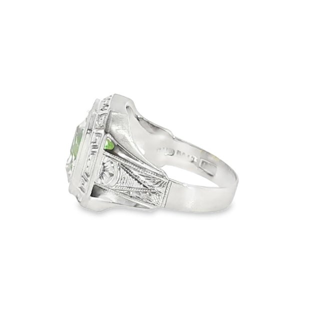 A mid-century 10k white gold ring featuring a radiant-cut synthetic green peridot (August birthstone). The design is...