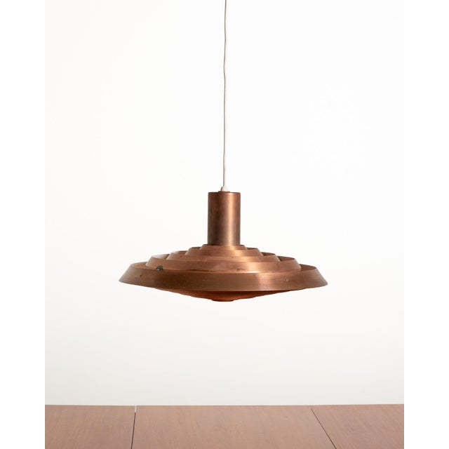 Copper pendant lamp with a system of concentric diffusers and white lacquered interior surfaces. "Tallerken" model by Poul...