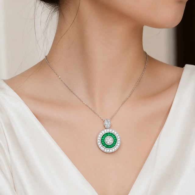 18K White Gold Diamond Baguette Emerald Designer Pendant Necklace. This elegant pendant features 21 tapered baguette...