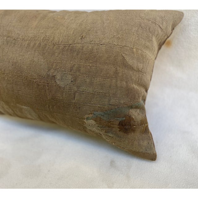 Elegant decorative pillow upholstered in a fine-weave early 19th-century tapestry, featuring a beautifully muted, time-...