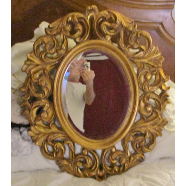 NEW Ornate Baroque Carved Style Gold Leaf with Black Rub Oval Bevelled Mirror Measures 29.50" x 25.50" overall. The...
