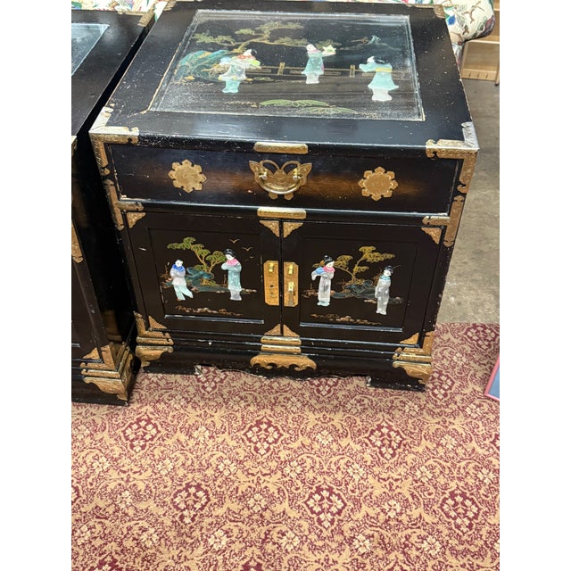 Elegant and richly detailed, this pair of vintage Chinese cabinets showcases the timeless artistry of traditional...