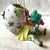 Whimsical and charming small bisque floral vase in the form of a young boy carrying a large egg vessel on his back. We...