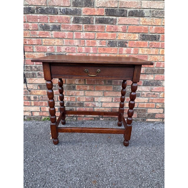 This table is a William and Mary bobbin-turned oak side table, a popular furniture design that originated in the late 17th...