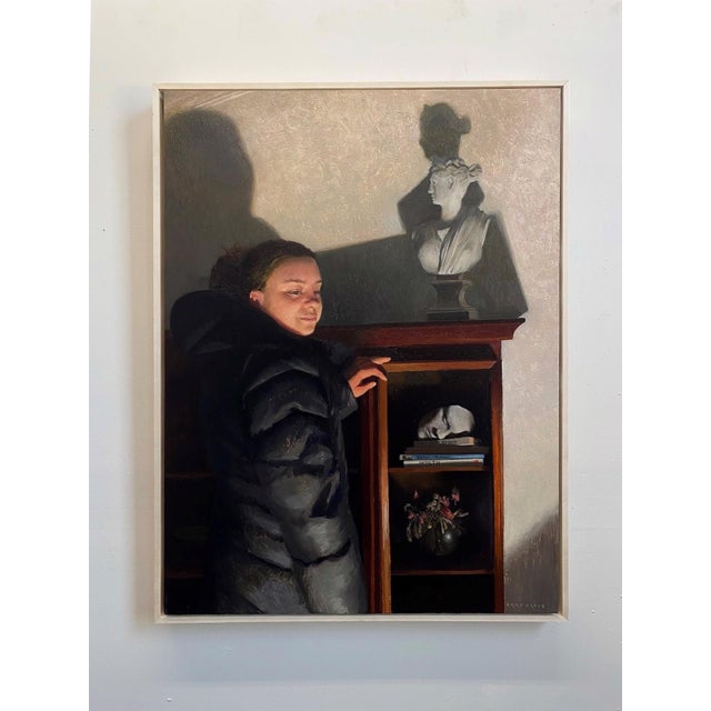 In "Noumena," a figure stands beside a wooden shelf, their expression illuminated by soft light that accentuates the...