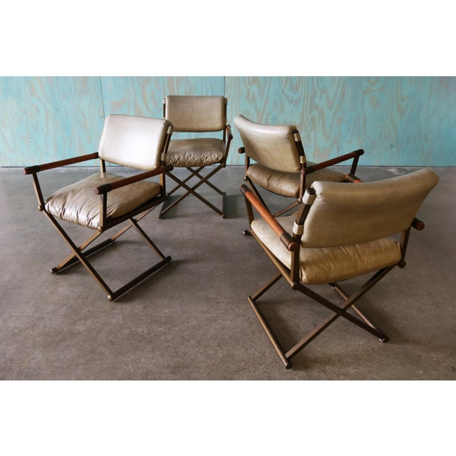 A set of 4 director chairs in oak, gold plated steel, and light tan vinyl cushions. Great design and super comfortable....