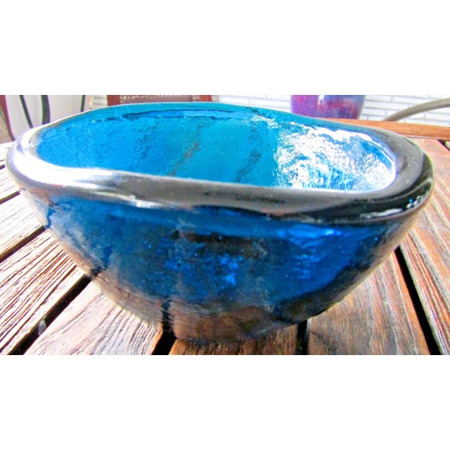 The product is a vintage Italian Mid-Century Blue Murano Glass Free Form Bowl from the 1950s. This decorative bowl is made...