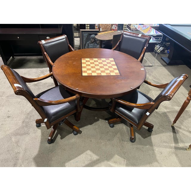 A handsome and substantial game table set by Hillsdale Home, crafted in richly finished dark wood and paired with...