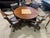 A handsome and substantial game table set by Hillsdale Home, crafted in richly finished dark wood and paired with...