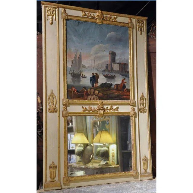 This elegant antique trumeau mirror was crafted in Versailles, France circa 1770 and beautifully reflects the refined...