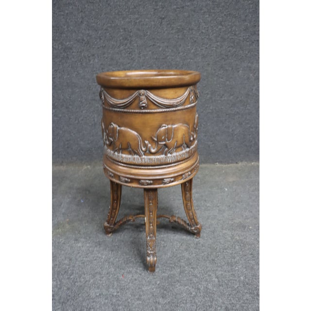 Decorative metal planter attributed to Maitland Smith, featuring a richly detailed cylindrical body adorned with a...
