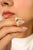 Crafted in 18k yellow gold, this unisex dome ring features a 0.31 carat emerald cut natural emerald and 0.31 carats of...