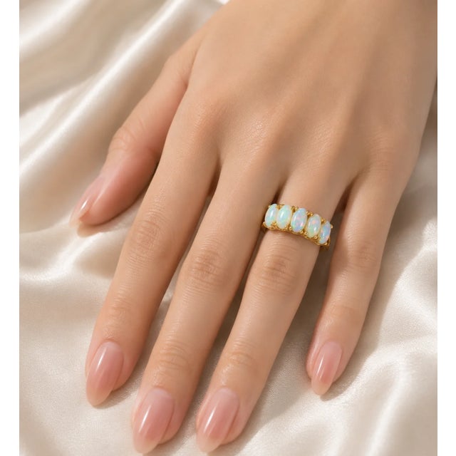 Elegant 14K yellow gold band ring featuring five natural oval opals. Estate piece with 1/4 inch wide band, size 6.75,...