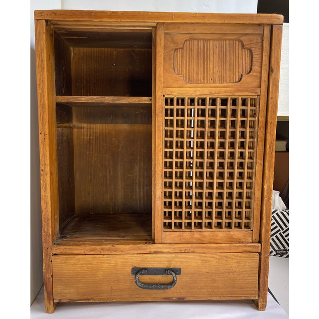 This is a handsome and useful Japanese Tansu Tabletop Storage Cabinet with two sliding grid patterned lattice doors with a...